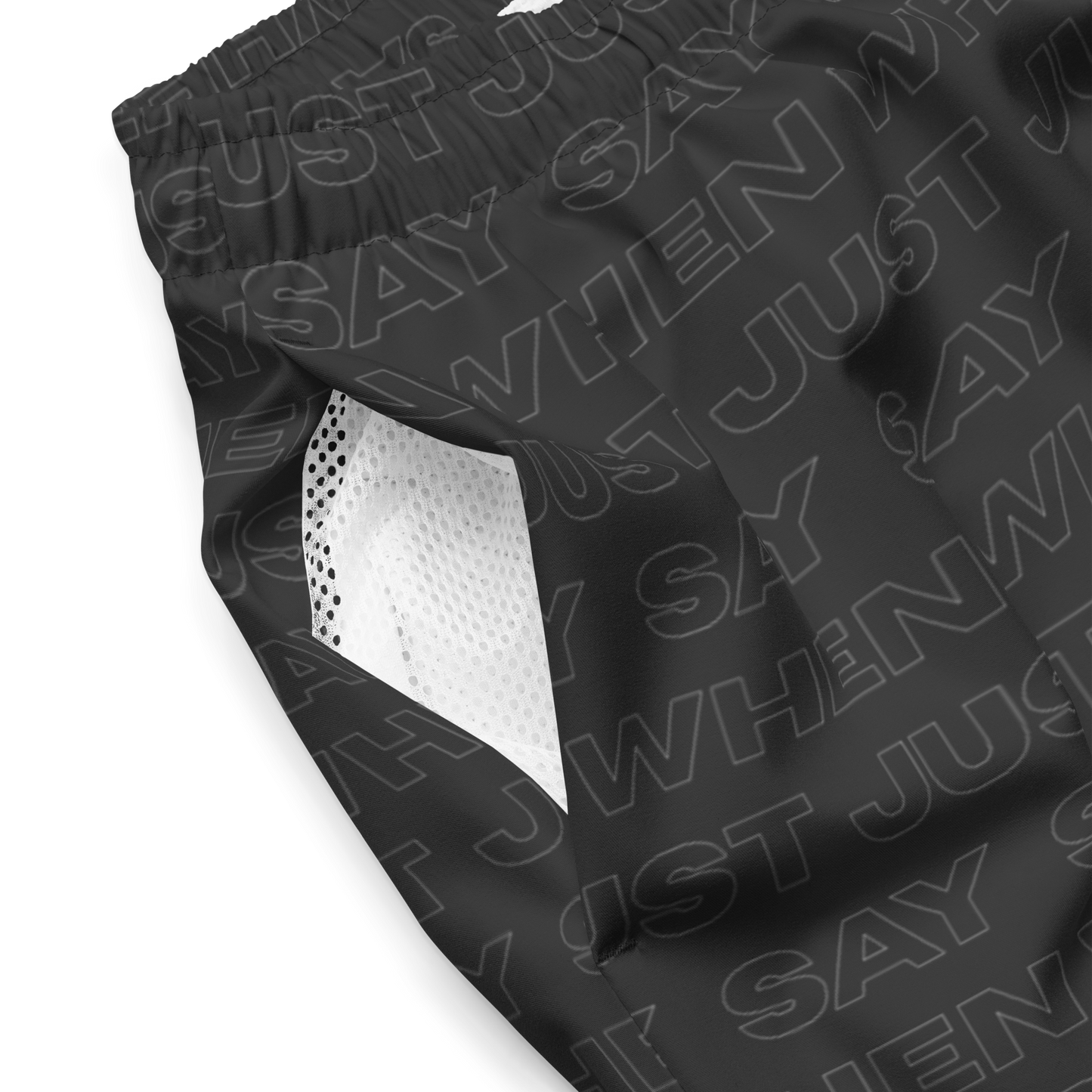 close-up detail of the capital swim shorts showing breathable white mesh lining and black fabric with an all-over 'just say when' pattern.