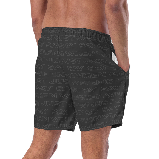 back view of the model wearing the capital swim shorts in black featuring an all-over 'just say when' pattern.