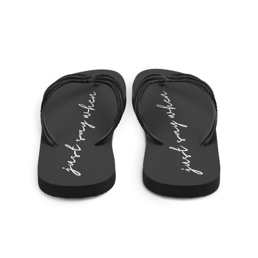 rear view of the just say flip-flops in black featuring white cursive text that reads ‘just say when’.