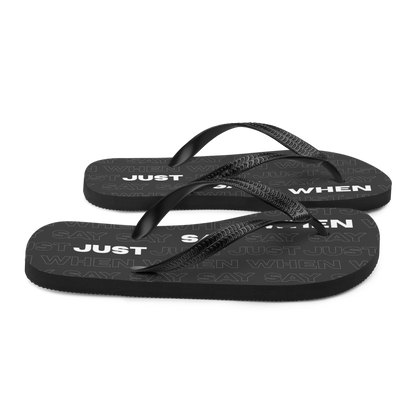 right view of the capital flip-flops in black with bold white ‘just say when’ text and a subtle repeating pattern.
