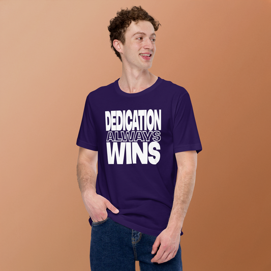 model wearing the purple dedication shirt featuring bold white text that reads 'dedication always wins' across the chest.