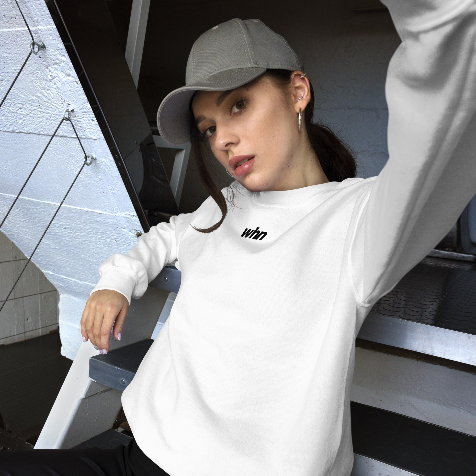 model wearing the humble sweatshirt why sitting on stairs