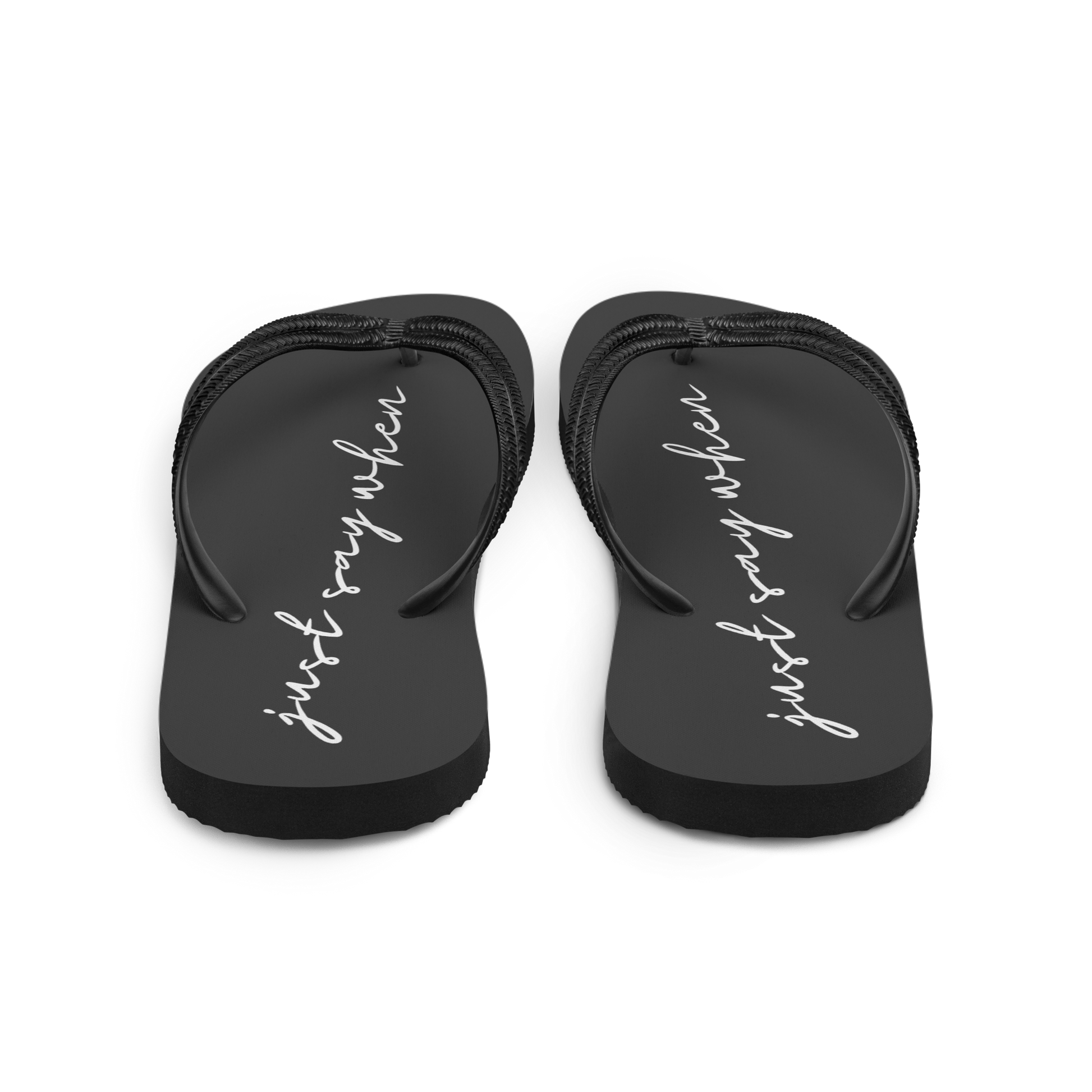rear view of the just say flip-flops in black featuring white cursive text that reads ‘just say when’.